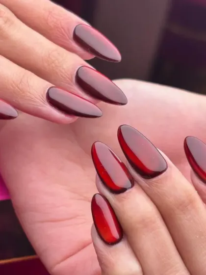 A close up of my deep cherry red jelly nails. This look is achieved by layering sheer gel polish to create a glossy, translucent effect that has incredible depth, perfect for a bold yet sophisticated statement.