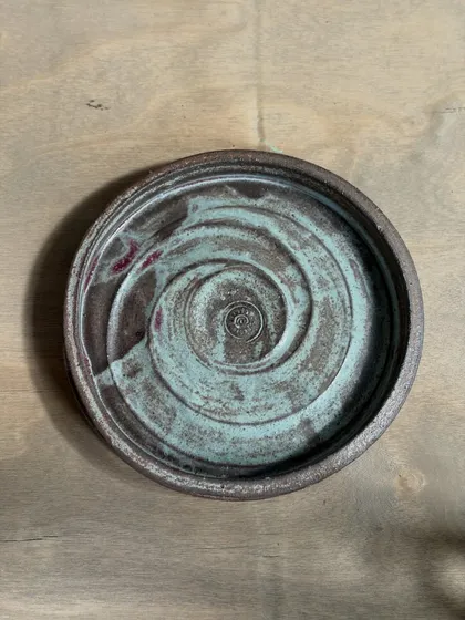 Another variation of our handmade side plate, this one showing a beautiful turquoise swirl. The interaction between our custom glazes and different clay bodies creates these happy accidents.