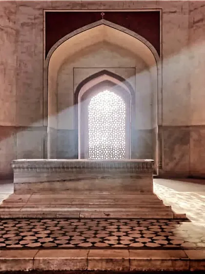 The cenotaph of Emperor Humayun, with light streaming through a jali screen. The actual grave lies in a chamber below. We discuss the symbolism and design of Mughal funerary architecture here.