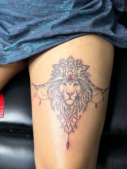 A lioness is still a queen. This ornamental lion tattoo on the thigh is a popular design for women who want to represent their strength and independence.