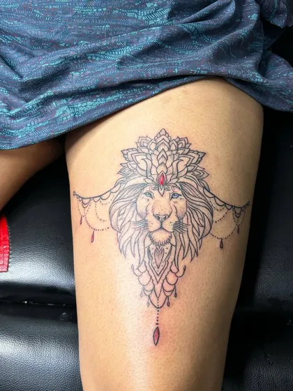 A lioness is still a queen. This ornamental lion tattoo on the thigh is a popular design for women who want to represent their strength and independence.
