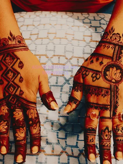 For a unique back-of-hand design, I combine different elements like geometric patterns, lotus motifs, and jewellery-style chains. This creates a stylish and unconventional look.