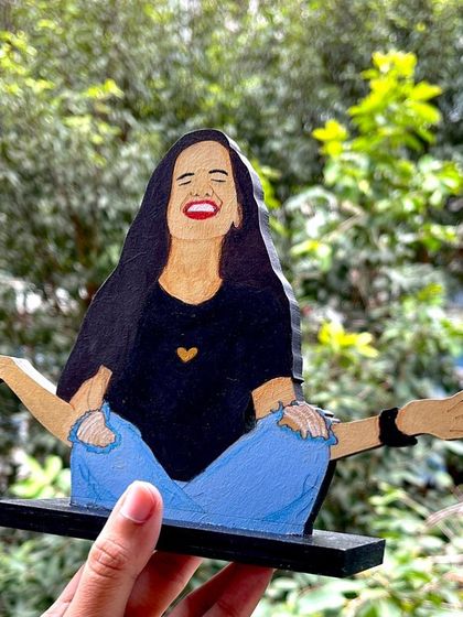 A fun and expressive wooden miniature capturing a joyful, carefree moment. These make for fantastic personalized gifts that showcase personality.