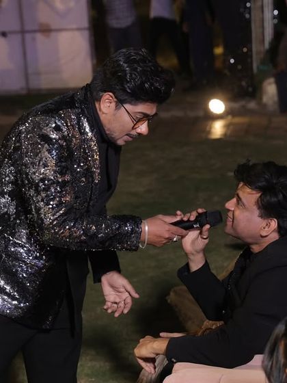 Interacting with a guest during a Sangeet. I make it a point to move around and engage with the audience, not just stay on stage.