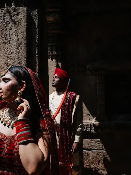 A portrait that plays with light and shadow within the stunning architecture of a heritage site. The bride is illuminated while the groom remains in the shadows, creating a sense of depth and mystery in this cinematic couple shot.