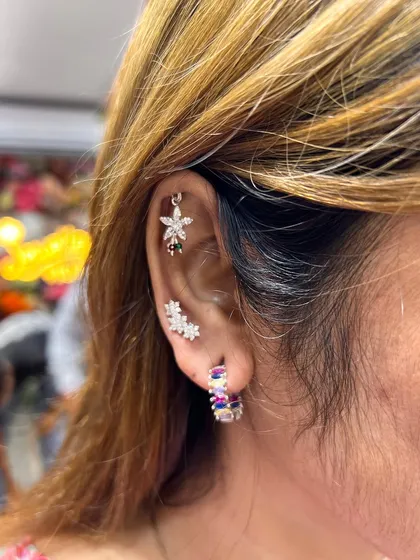 A vibrant and colorful ear stack. We combined multi-colored floral studs with sparkling hoops to create a look that is full of personality and joy.