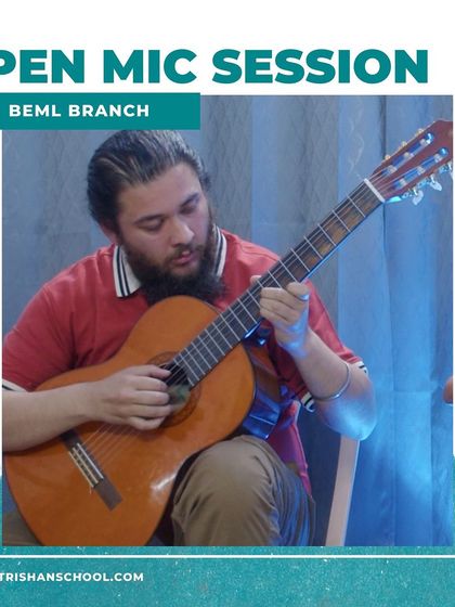 A photo of a teacher or advanced student playing a classical guitar at our BEML branch open mic.