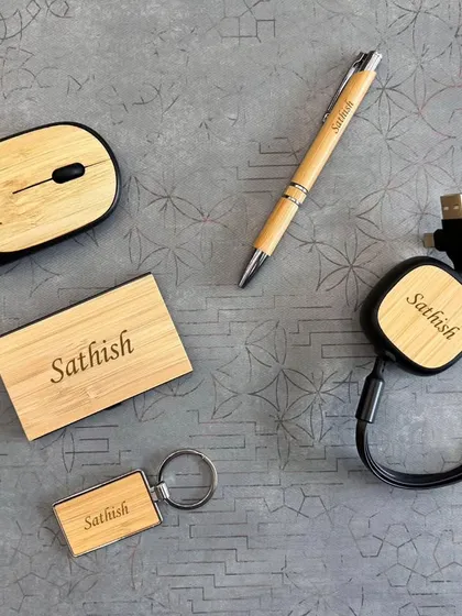 This set combines eco-friendly materials with modern technology. It includes a wireless bamboo mouse, a retractable 3-in-1 USB cable, and other bamboo accessories, all personalized for "Sathish".