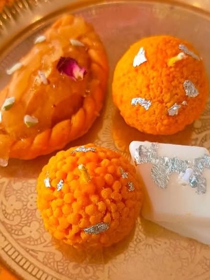 A simple, elegant shot of my most popular mithai candles: Gujiya, Motichoor Ladoo, and Kaju Katli. Placed on a brass plate, you can see how their realistic details and textures make them a stunning decorative item.