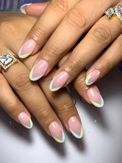 A delicate and pretty French manicure with pastel yellow and blue double tips.