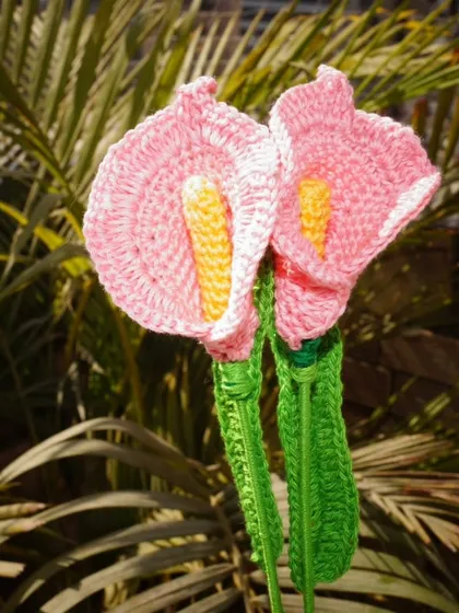 My handmade pink calla lilies enjoying some sunshine. The durable cotton yarn ensures their color stays vibrant even in the light.