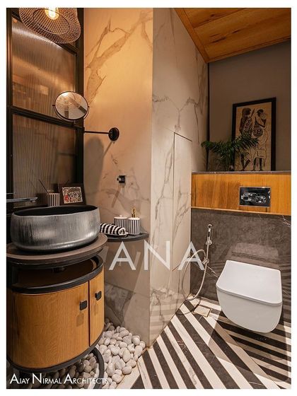 The powder room in Apartment 704 is compact yet full of character. It features bold black-and-white themed tiles, a floor-mounted basin, and a wooden ceiling, all enclosed by a dark green partition with fluted glass to maintain a sense of openness.