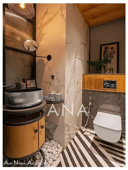 The powder room in Apartment 704 is compact yet full of character. It features bold black-and-white themed tiles, a floor-mounted basin, and a wooden ceiling, all enclosed by a dark green partition with fluted glass to maintain a sense of openness.