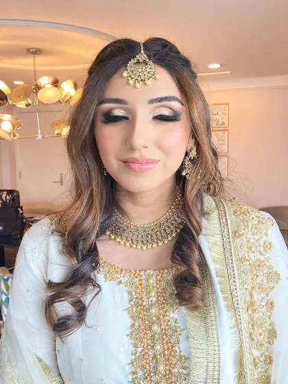 A softer angle of this elegant look, showing the beautiful shimmer on the eyelids. The makeup is subtle yet impactful, designed to enhance her features for her special day.