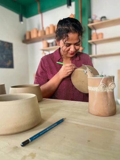 A student working on her intricate pieces for the upcoming pop-up.