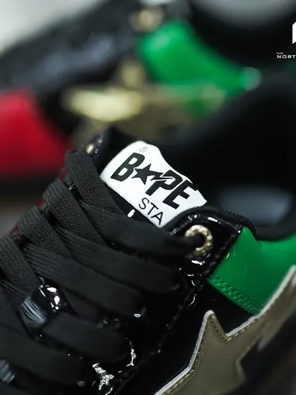 Detail of the BAPE STA logo on the tongue of the Dubai Anniversary edition, set against the green patent leather.