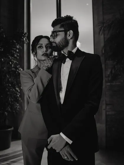 Serving bold looks for the after-party. This black and white shot captures the high-fashion vibe of the couple's stylish celebration.