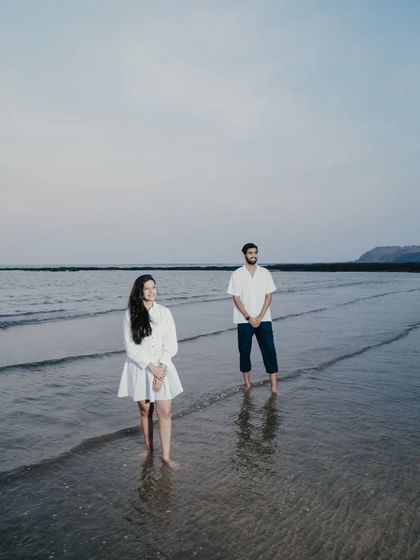 A serene and peaceful portrait of the couple standing in the shallow water, reflecting a sense of calm and togetherness.