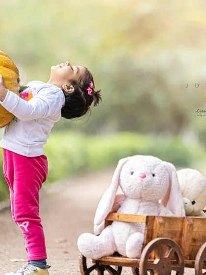 Stronger than she knows. I love using seasonal props like pumpkins to create fun, interactive scenes that result in spontaneous and joyful photos.