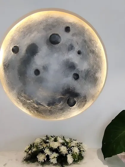 As a moon child, creating these 3D moon art pieces is pure therapy. This backlit installation brings a slice of cosmic calm indoors, with a textured surface that mimics the real moon, crafted sustainably from scrap materials.