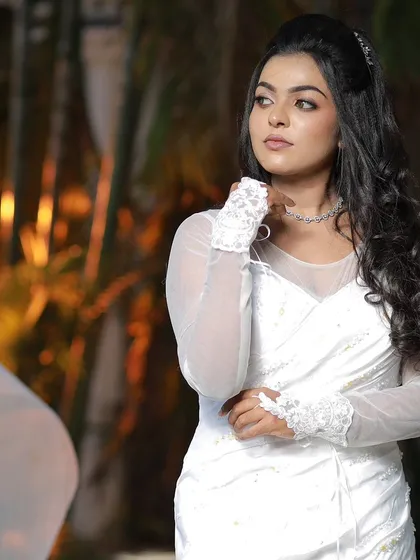 A model posing in a white gown, showcasing a modern and elegant Christian wedding look.
