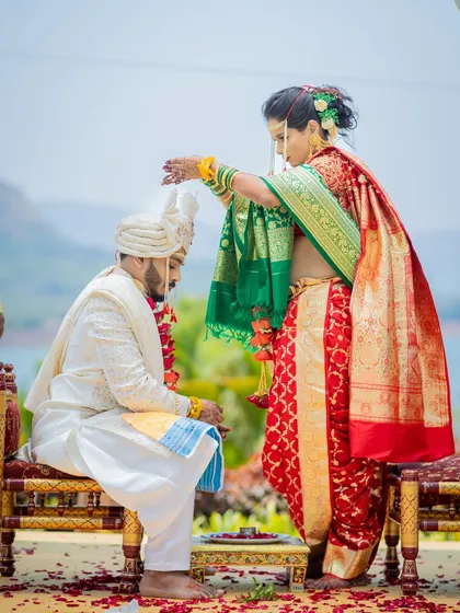 A key ritual where the bride showers the groom with sacred rice, a beautiful moment in a Maharashtrian wedding.