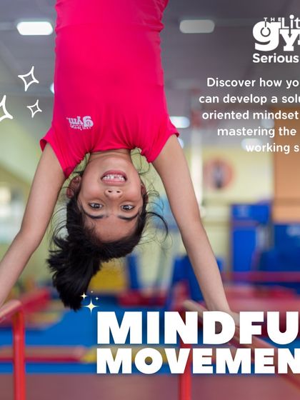 Mindful movement in action. A young girl hangs upside down from the bars, smiling. This not only builds strength but also offers a new perspective, boosting confidence and spatial awareness.