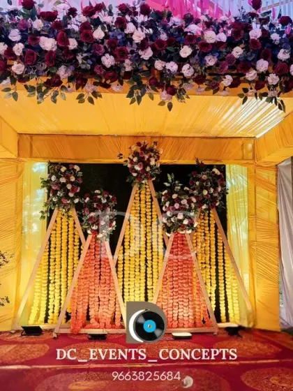 A traditional Haldi ceremony backdrop featuring pyramids of marigold flowers. The rich floral arrangements and yellow color scheme are perfect for this auspicious and joyful occasion.