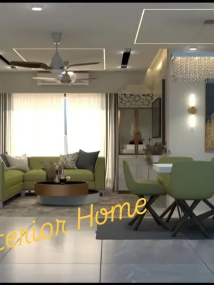 A luxurious living and dining room with vibrant green seating. The space is defined by its elaborate false ceiling with cove lighting and a stunning crystal chandelier.