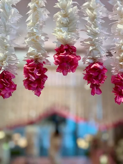 A soft-focus shot of the hanging floral decor, creating an artistic and dreamy image that captures the romantic essence of the wedding atmosphere.
