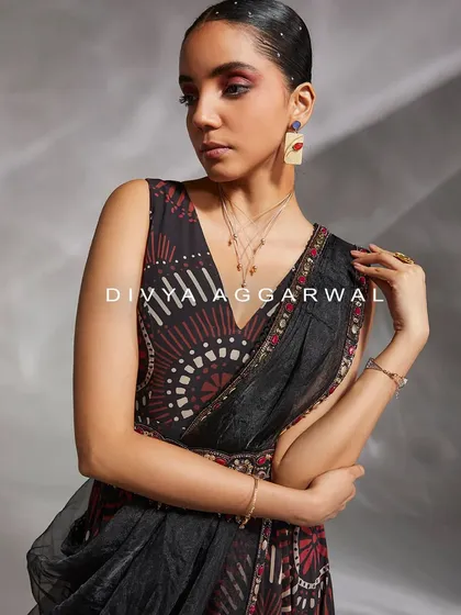 A close-up of our printed saree set, featuring a bold, abstract pattern in red and black. The look is modern, artistic, and perfect for making a statement.