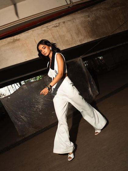 A walking shot that captures movement and attitude, perfectly suited to the urban, industrial setting.