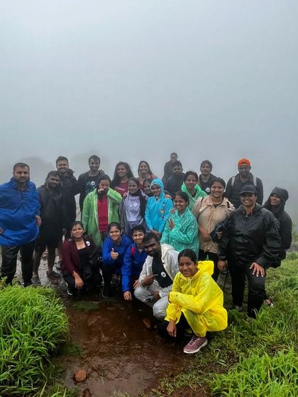 A wet but happy group photo in the middle of the rainy Bandaje trail.