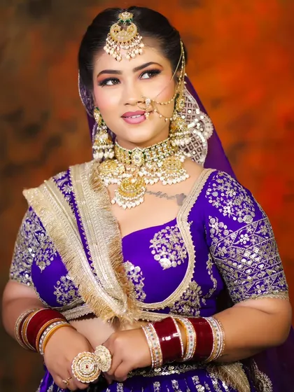 A three-quarter profile of the bride, showcasing the complete look with her dupatta. You will learn how to drape and style dupattas to complete the bridal ensemble.