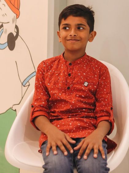 Aethen, sitting thoughtfully, represents the curious minds we nurture. From a "noob" on Zoom to a budding robotics engineer, his journey shows the power of hands-on learning.