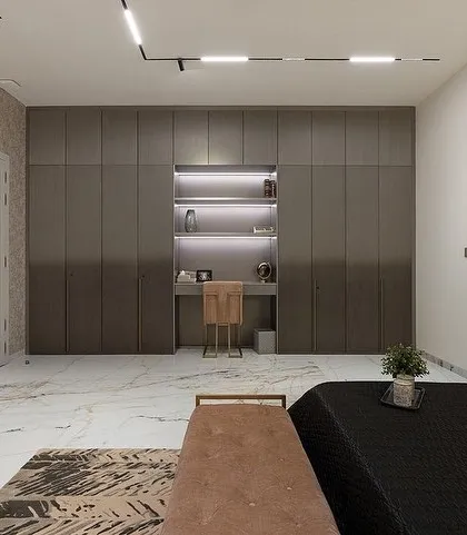 The same bedroom, showing the custom ombré grey wardrobe with an integrated study nook, designed for a modern, masculine aesthetic.