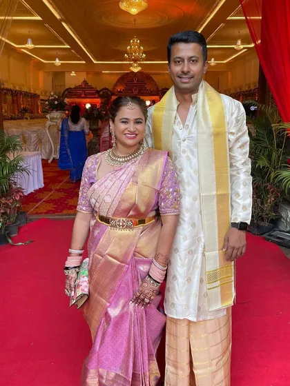 Our client Manasa and her husband at their celebration. She is glowing in a pure handwoven Kanchipuram silk saree in a beautiful shade of pink with a rich gold border.