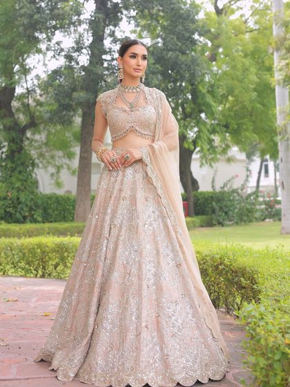 A full-length view of a stunning champagne-gold lehenga, perfect for a summer bride. The minimal design proves that simplicity can be incredibly impactful.