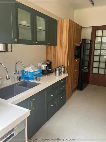 Functionality is key in this European-style kitchen. The layout provides ample counter space next to the sink and appliances, while glass-fronted upper cabinets keep the space feeling open and light.