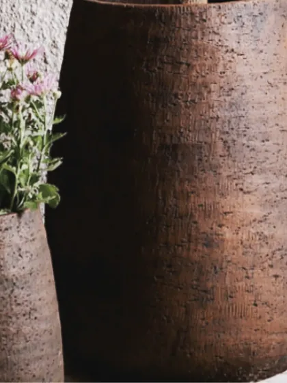 The texture on this 'Modernistic Enigma' planter is everything. The deep grooves and dark, earthy tones make it a piece of art in its own right. It provides a stunning contrast for both flowering plants and simple green foliage.