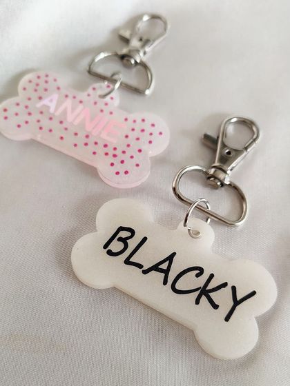 Another angle of the 'Annie' and 'Blacky' tags. They are lightweight, durable, and a stylish accessory for your pet's collar.