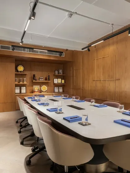 The conference room at the award-winning SIRCA HQ project. The room is paneled in warm wood, with comfortable seating and integrated technology, creating a space that is both beautiful and highly functional.