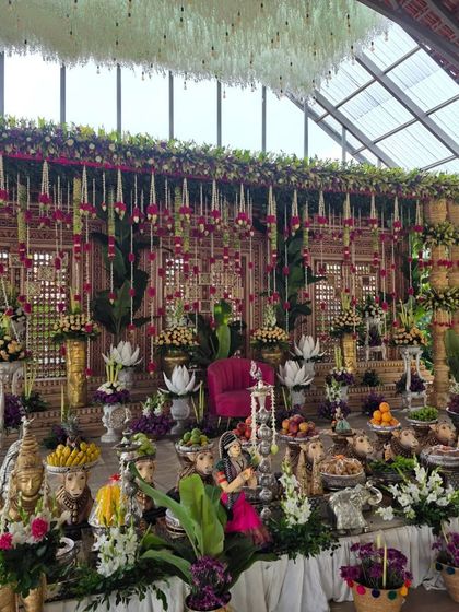 A closer view of the glasshouse venue setup, highlighting the intricate details of the offering table with cow props and dolls.
