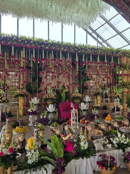 A closer view of the glasshouse venue setup, highlighting the intricate details of the offering table with cow props and dolls.