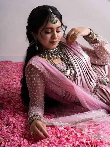 From my Maharani Series, this light pink Kanjivaram saree is where tradition meets modern artistry. I've adorned it with intricate zardozi and paired it with a net handwork blouse and a regal dupatta, a tribute to the ancient queens of India.