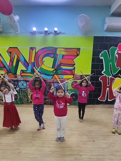 Our little ones practicing with dandiya sticks. We introduce props early on to help with coordination and to teach them different styles of folk dance in an engaging way.