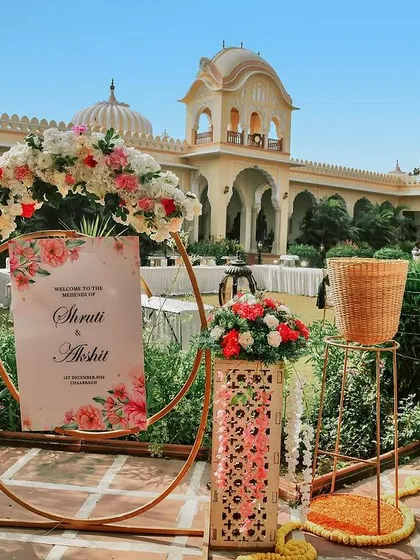 A close-up of the beautiful welcome sign and floral decor at a destination mehendi. These details create the atmosphere and we make sure to capture them.