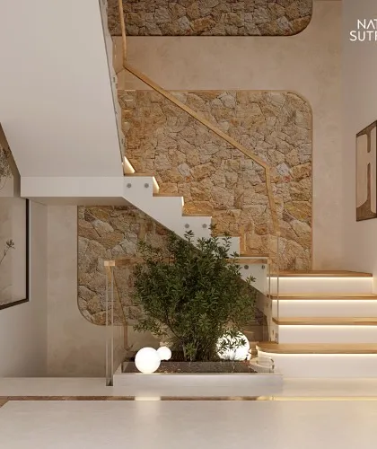 A staircase can be more than a transition; it can be the heart of the home. For this project, we designed a floating staircase against a backdrop of rough-cut stone, with an integrated planter that brings life and nature indoors. The under-step lighting adds a layer of warmth and drama.