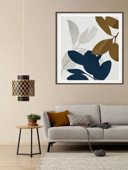 A single, large framed print of abstract leaves in shades of blue, brown, and beige. This piece makes a sophisticated statement and is perfect for a room with a neutral or earthy color scheme.