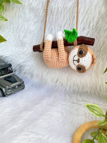 This adorable sloth car hanging was so much fun to make. He hangs lazily from a real wooden branch, adding a touch of cuteness to your car's rearview mirror.